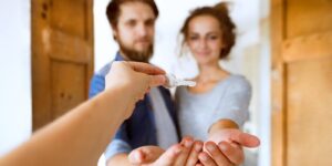 Young couple holding the key to a Colorado home passed by beneficiary deed