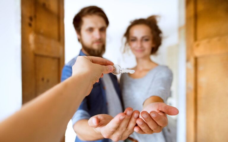 Young couple holding the key to a Colorado home passed by beneficiary deed