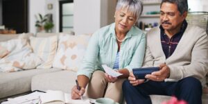 Senior couple reviewing estate planning costs and finances at home