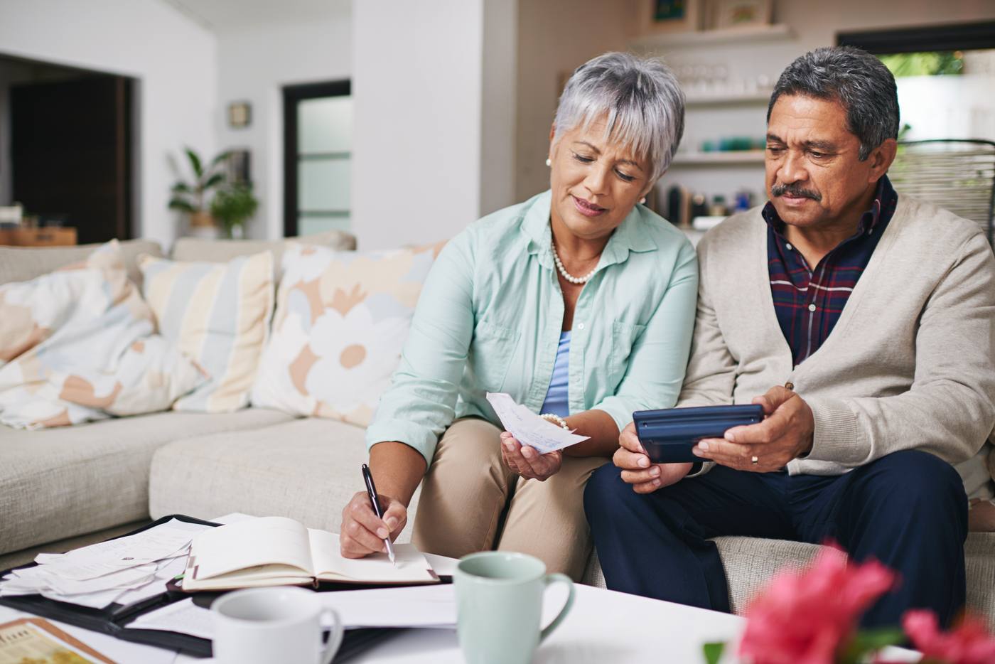 Senior couple reviewing estate planning costs and finances at home