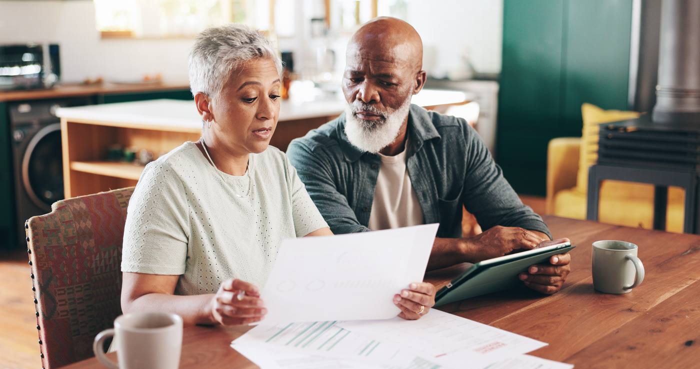 Senior couple reviewing estate finances together at home