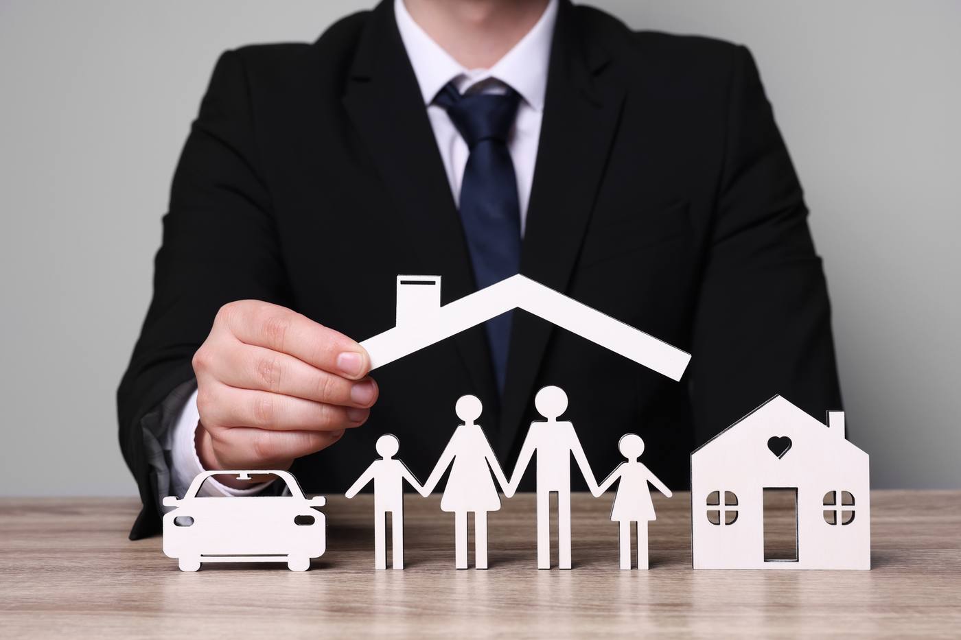 Paper cutouts of a family with home, representing a family estate plan