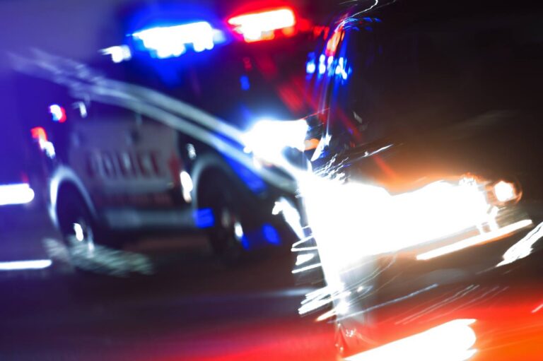 Police pursuit at night, illustrating hit-and-run UM claims