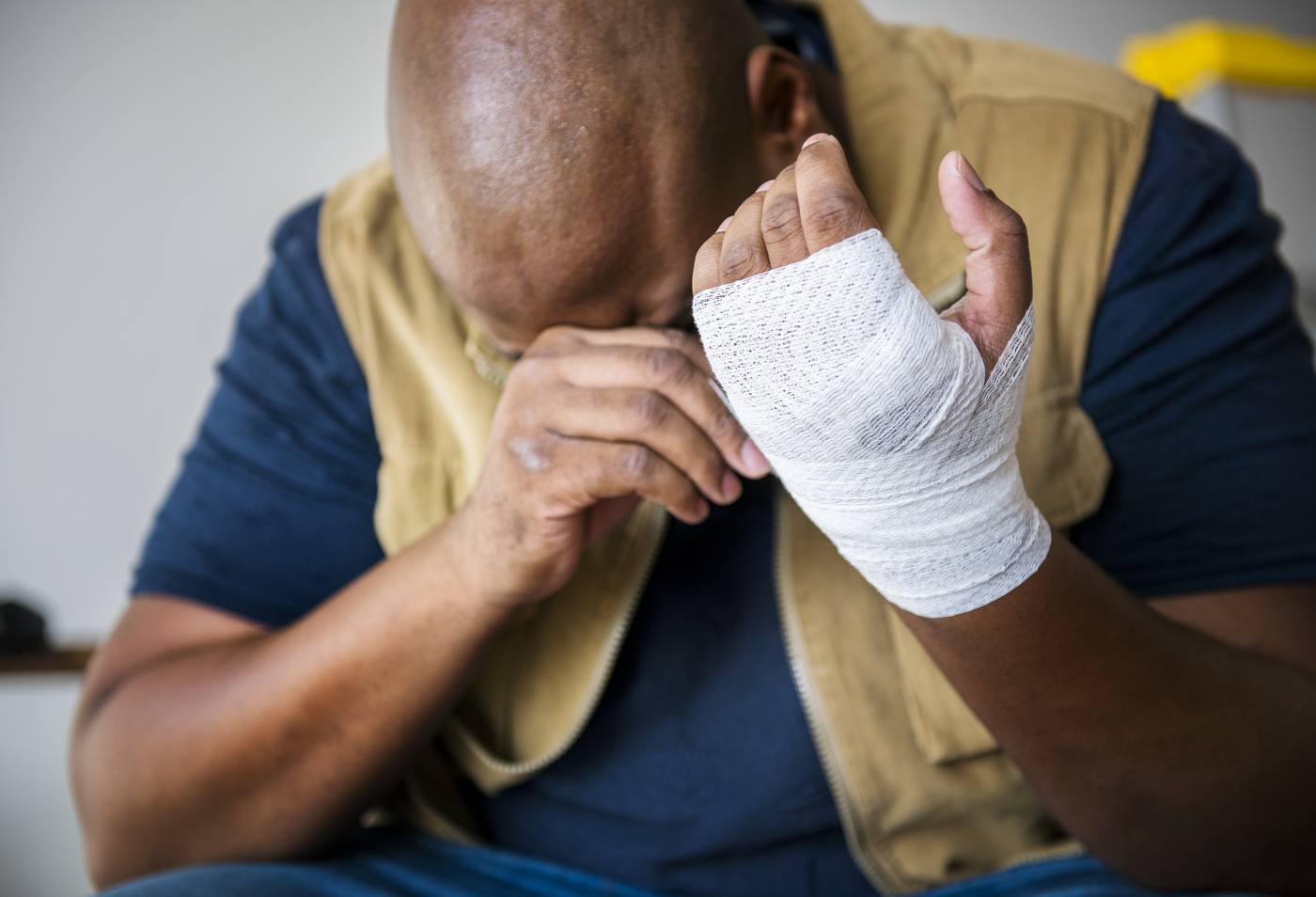 Injured man with bandaged hand considering legal representation