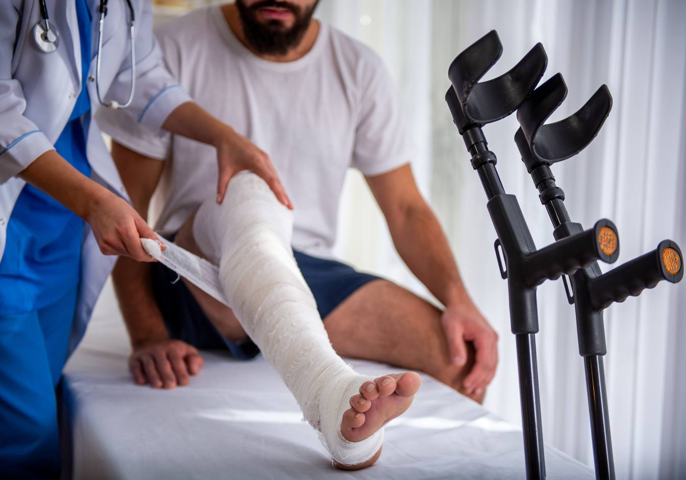 Healthcare professional treating an injured patient with a bandage