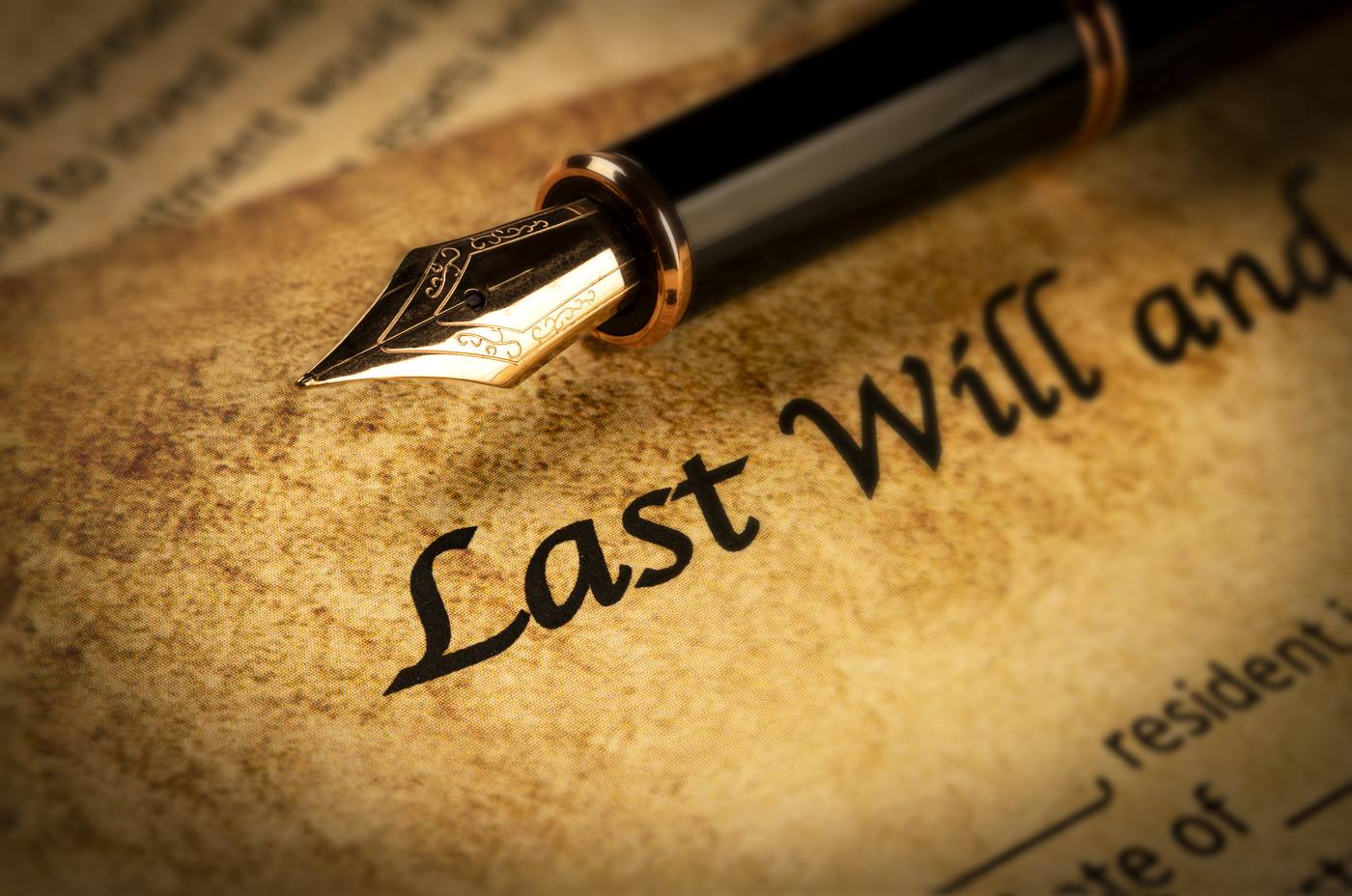 Antique fountain pen resting on a legal document