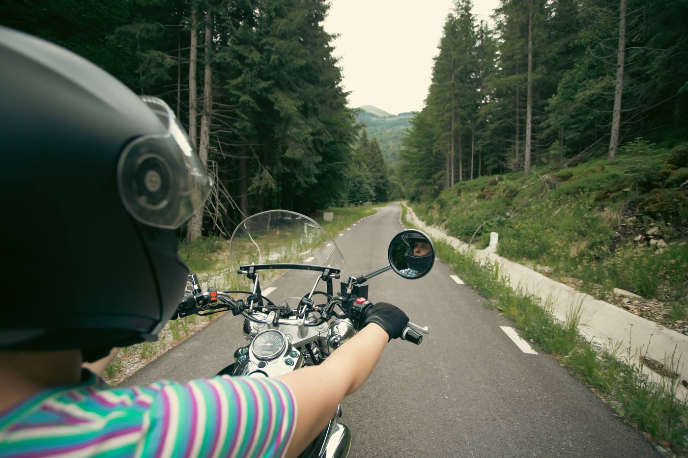 Rider with her motorcycle and helmet