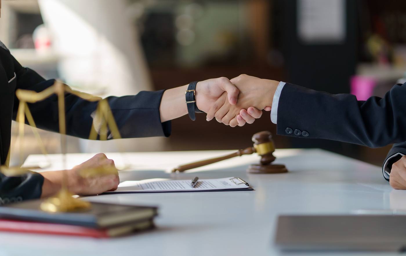 Lawyers reaching a settlement agreement during an office meeting