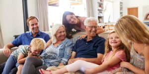 Family sharing a joyful moment on the couch, representing care planning
