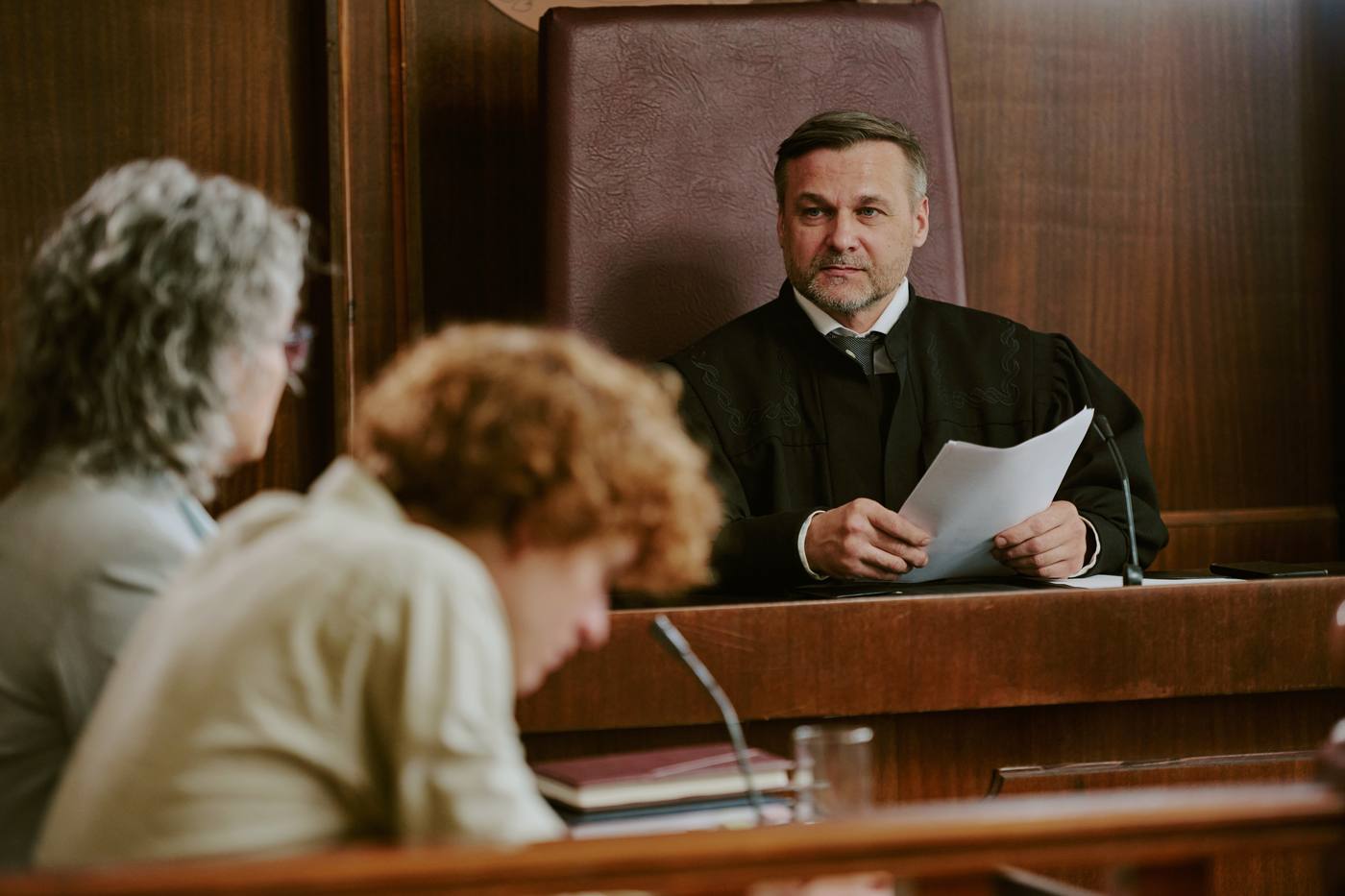 Judge presiding in a courtroom with attorneys present