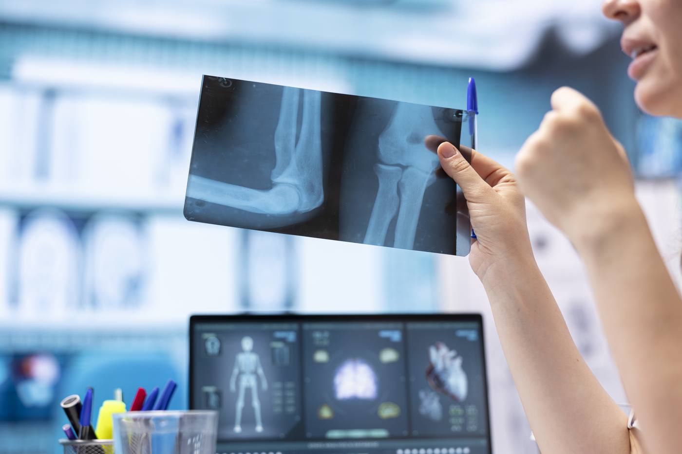 Attorney reviewing a defective tool involved in an on-the-job injury with safety reports and photos